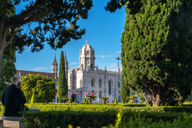 пожилой человек сидит, наблюдая за монастырем джеронимо - mosteiro dos jeronimos audio стоковые фото и изображения