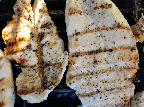 Close-up of chicken breasts on a backyard barbecue grill with grill marks, July 14, 2019