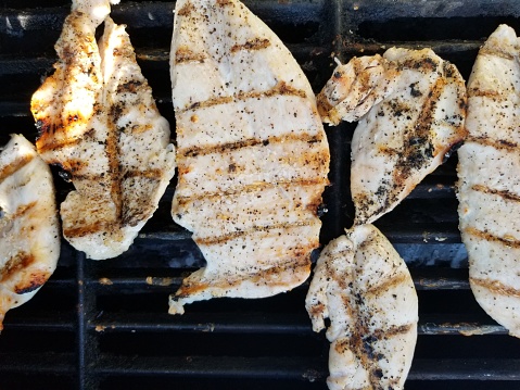 Close-up of chicken breasts on a backyard barbecue grill with grill marks, July 14, 2019