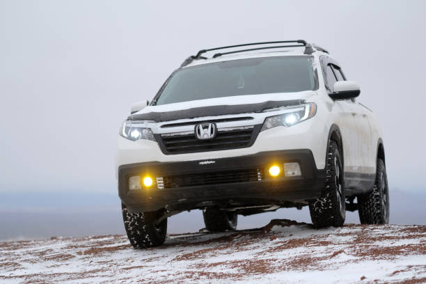 Honda Ridgeline atop a Snowy Butte stock photo