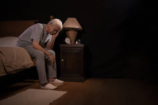istock Depressed senior person sitting in bed cannot sleep from insomnia 1162879043