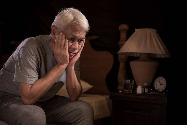 istock Depressed senior person sitting in bed cannot sleep from insomnia 1162879053