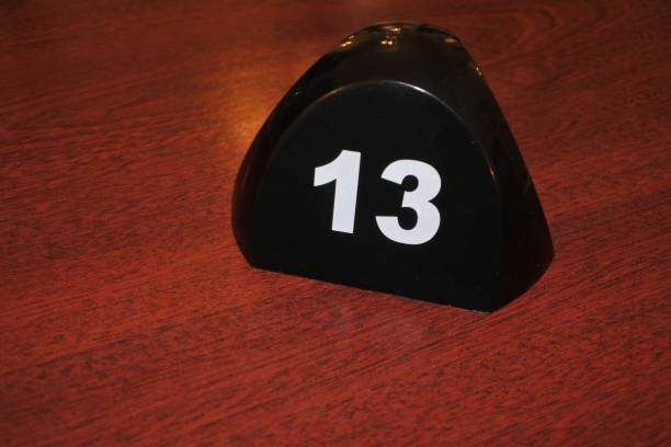 istock Number 13 table number on a wooden table 1162880588