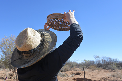 Australian woman fossicking (searching)  gem stones in the outback of the Northern Territory, Australia.