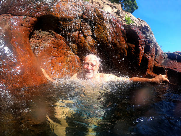 senior man having fun at wangi falls northern territory of australia - wangi falls imagens e fotografias de stock