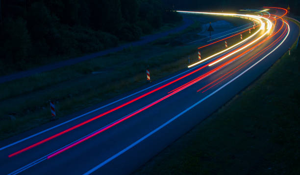 istock lights of cars with night 1162887565
