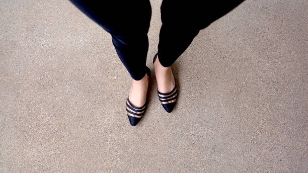 Low heel shoe on cement background, Top view.
