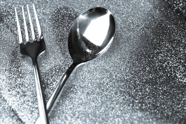 istock Silver or platinum spoon on glitter silver dust background ,Luxury and elegant concept 1162894799