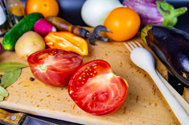 Vegetable tomato on a cutting board. Food photo. Background. Place for text. Cooking food. Kitchen.