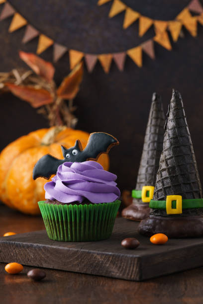 istock Halloween treats - cupcake, cookie bat and wafer witch hats 1162900424
