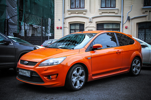 Moscow, Russia - September 29, 2012: Orange car Ford Focus ST in the city street.