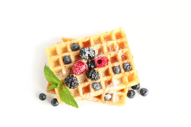 istock Waffles with berries and mint isolated on white background 1162904720