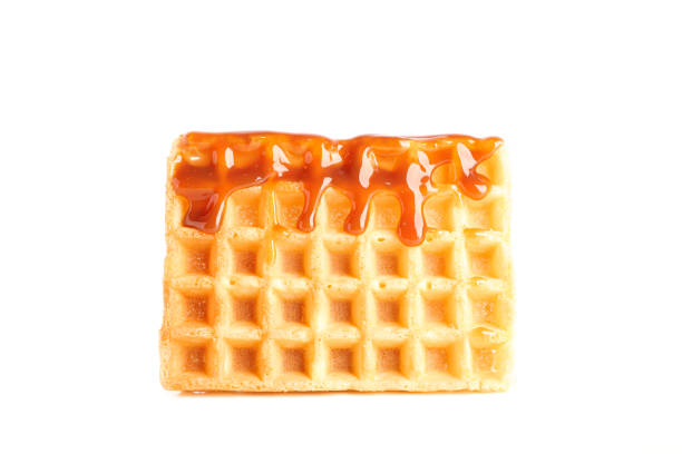 istock Waffle under caramel topping isolated on white background 1162905335
