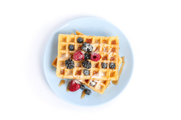 istock Waffles with berries on plate isolated on white background 1162905357