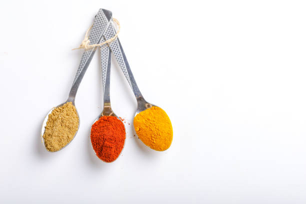 istock Various spices ( cumin, coriander, curry, paprika, chili, turmeric cinnamon, fenugreek, cardamom, basil leaf, parsley, cloves )  in  spoons on white background. Top view with copy space. 1162905465