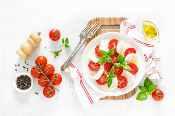 istock Fresh italian Caprese salad on white plate, view from above 1162905747