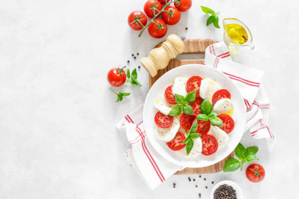 istock Fresh italian Caprese salad on white plate, view from above 1162905765