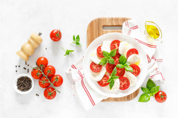 istock Fresh italian Caprese salad on white plate, view from above 1162905791
