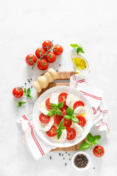 istock Fresh italian Caprese salad on white plate, view from above 1162906386