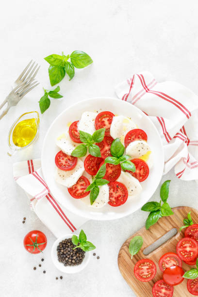 istock Fresh italian Caprese salad on white plate, view from above 1162906423