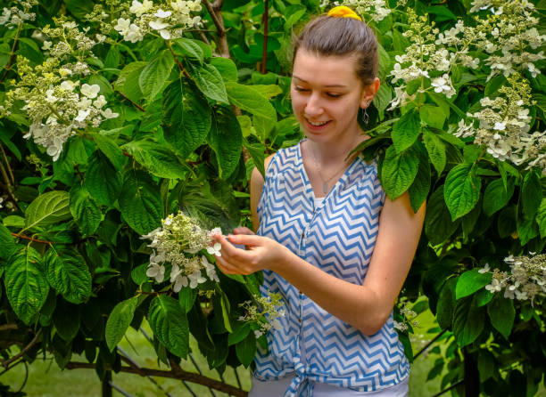 istock Young woman and flowers 1162906443