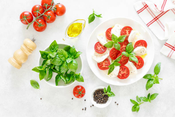 istock Fresh italian Caprese salad on white plate, view from above 1162906460