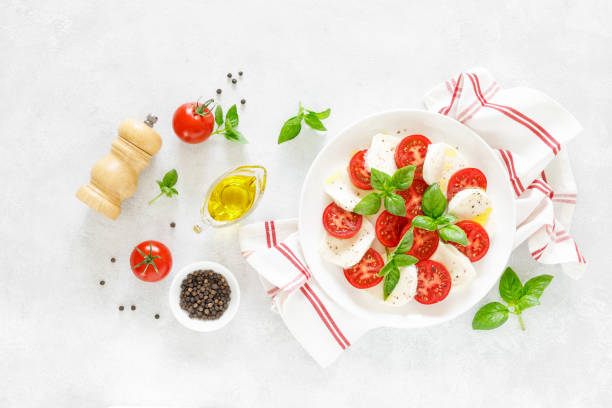 istock Fresh italian Caprese salad on white plate, view from above 1162906497