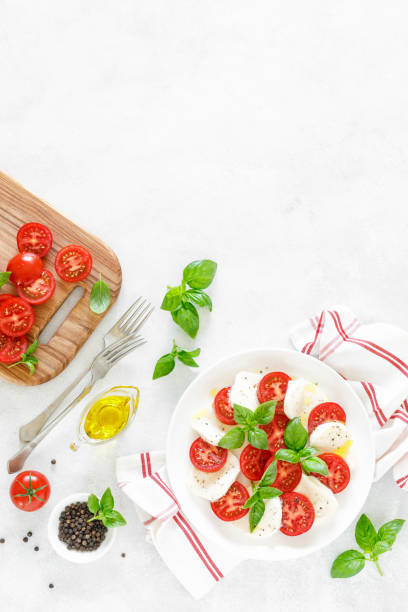 istock Fresh italian Caprese salad on white plate, view from above 1162906593