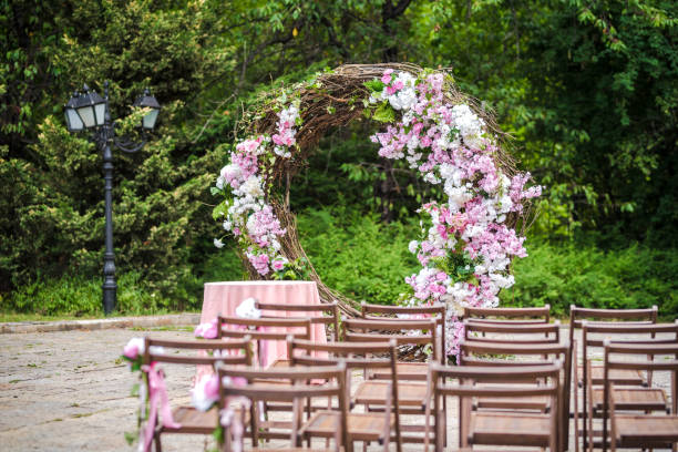 Round wedding arch with fresh flower decoration in pink and white