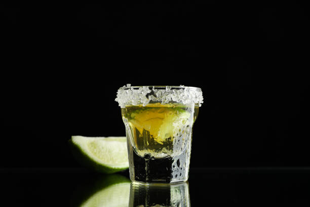 istock Tequila shot with lime and sea salt on black background 1162909863