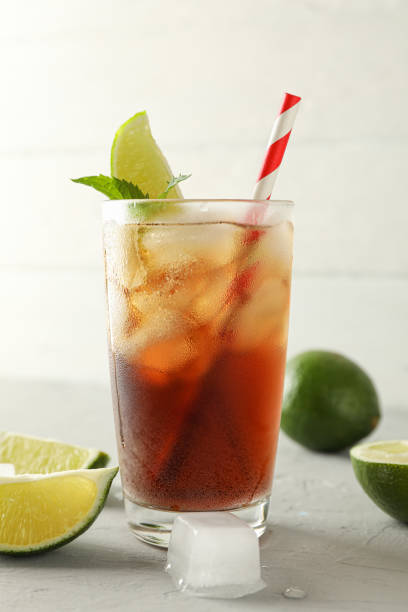 istock Glass with cold cola and citrus on grey cement background, space for text 1162909873