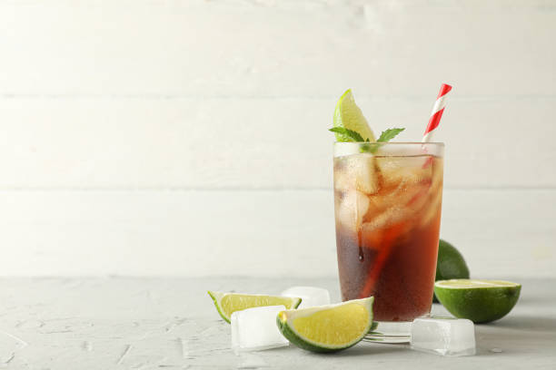 istock Glass with cold cola and citrus on grey cement background, space for text 1162910330