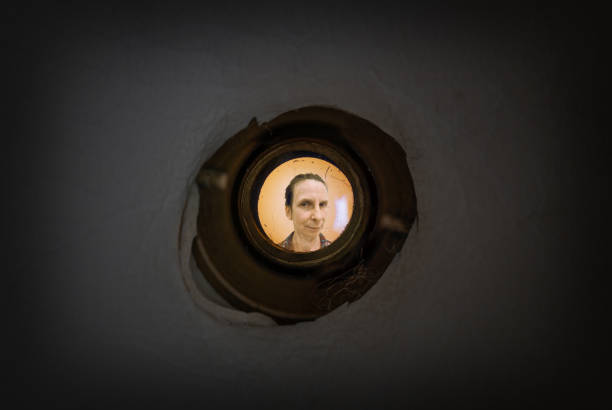 istock Woman seen through the peephole 1162911244