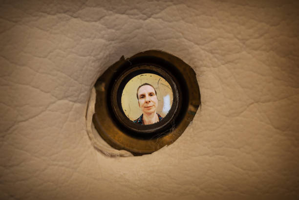 istock Woman seen through the peephole 1162911286