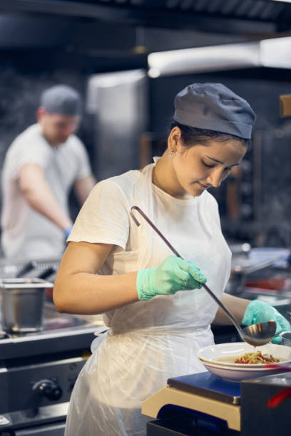 istock Woman cook at work in a modern kitchen, kitchen workflow in a kitchen., Copy space for text 1162911790