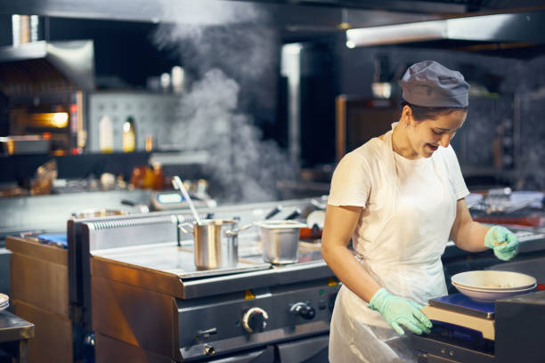 istock Woman cook at work in a modern kitchen, kitchen workflow in a kitchen., Copy space for text 1162911791