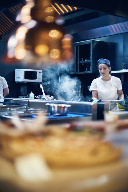 istock Woman cook at work in a modern kitchen, kitchen workflow in a kitchen., Copy space for text 1162911796