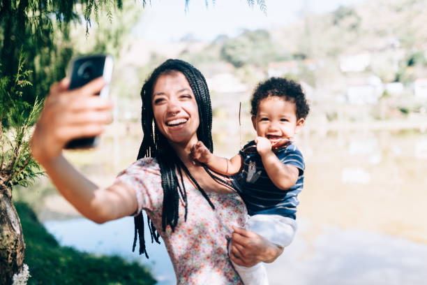 istock Young African descendant mother taking a selfie with her son 1162914986