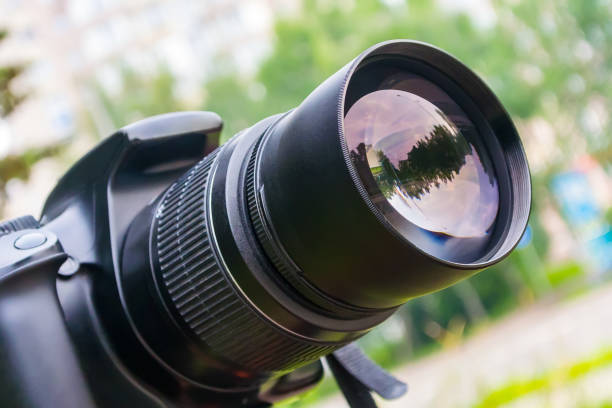 istock Close-up camera lens during shooting in city park in summer 1162915716