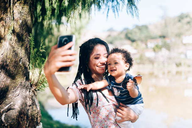istock Young African descendant mother taking a selfie with her son 1162915832