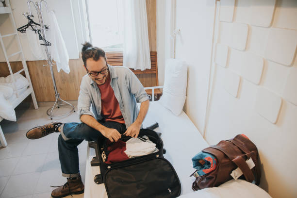 istock Hipster man open suitcase on his vacation 1162915941