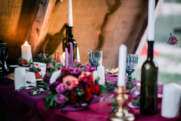 istock Delicate wedding white cake decorated with pomegranate and succulent surrounded by flowers and candles. 1162916762