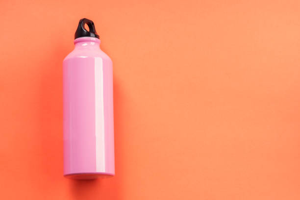 istock Pink thermos on orange coral. 1162918206