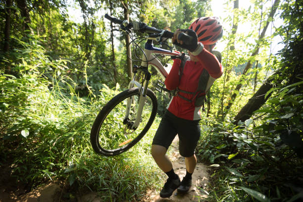 istock Woman cyclist carry a mountain walking on tropical forest 1162923227