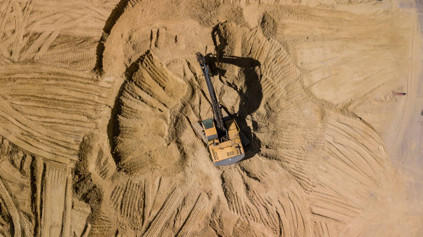 istock Aerial view of excavator working in construction site. 1162924159