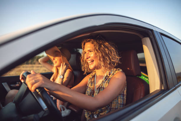 istock Female driver laughing while driving home from a field trip 1162925217
