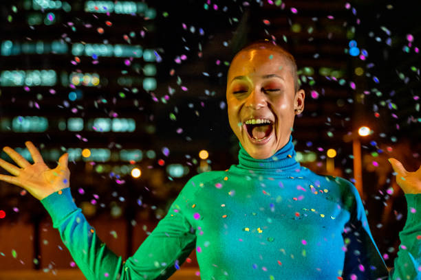 istock Cool woman under a rain of confetti 1162925572