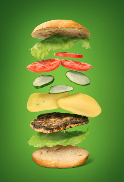 istock Burger ingredients flying on a green background 1162926935