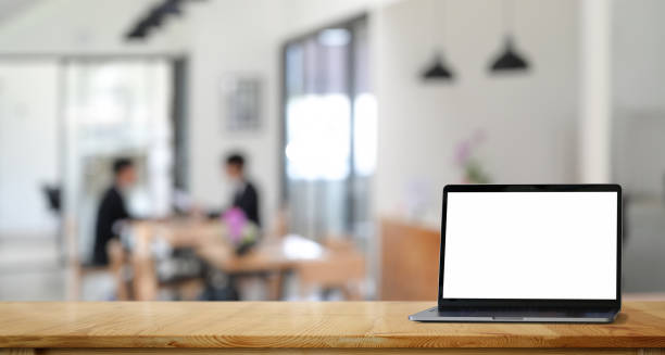 istock Work place concept : Mock up Blank screen laptop in loft office or co-working background.