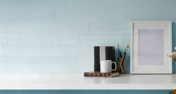 istock Mock up poster or photo frame on table hipster minimalism loft desk space, copy space